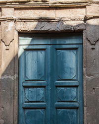 The stone door frame and the wooden door have aged gracefully together.