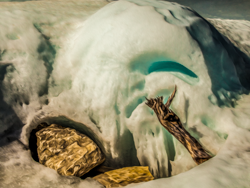 Nature at times constructs its own still life—a rounded rock placed carefully in the snow, a jaunty stick pointing inward, an igloo icy globe hovering in the background, a pleasing contrast of curvature and angularity.